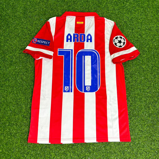 Red and white striped soccer jersey with number 10 and name 'Arda' on a green grass background