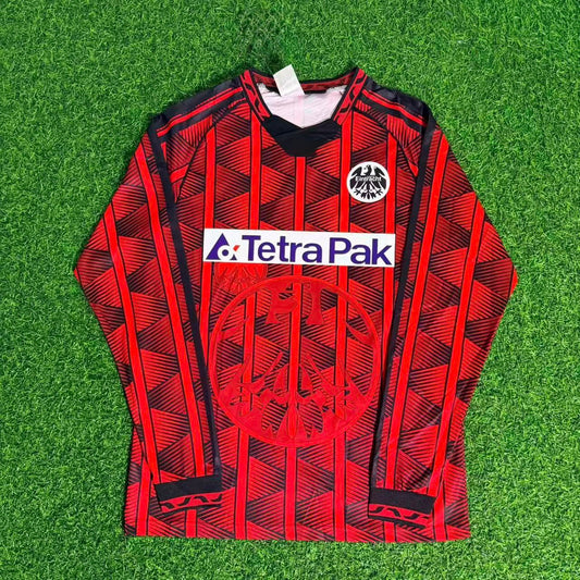 Red patterned hoodie with Tetra Pak logo on a green grass background