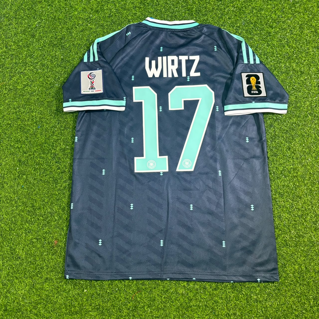 Dark blue sports jersey with 'Wirtz' and number '17' on a grass background