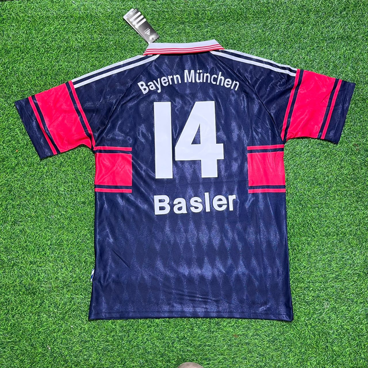 Bayern München soccer jersey with number 14 on a grass background