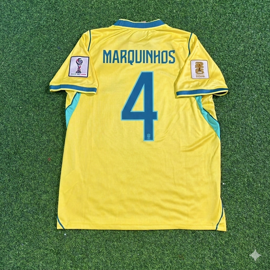 Maillot de football domicile jaune Marquinhos #4 Brésil Coupe du Monde 2026