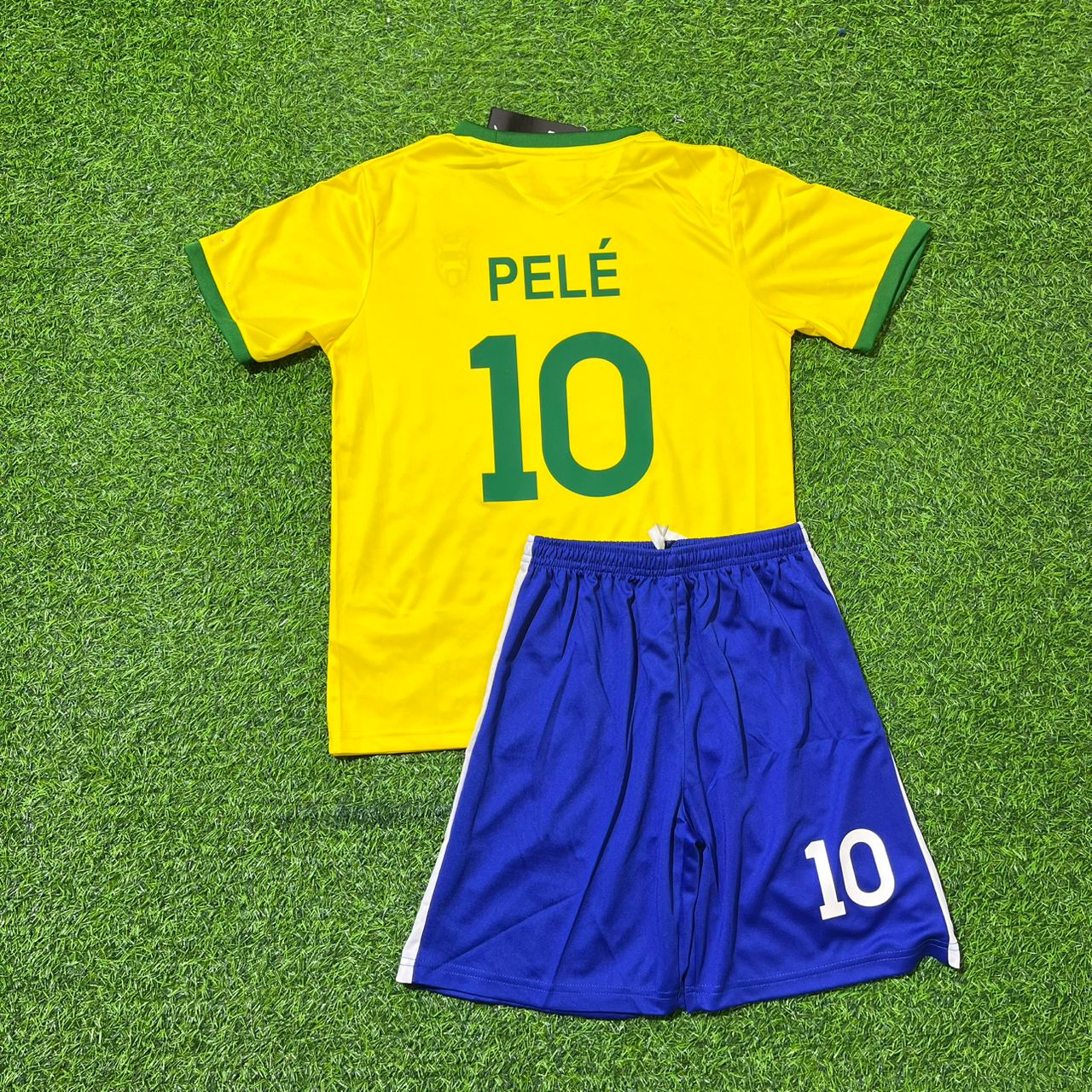 Yellow soccer jersey with 'PELE' and number '10' on a green grass background